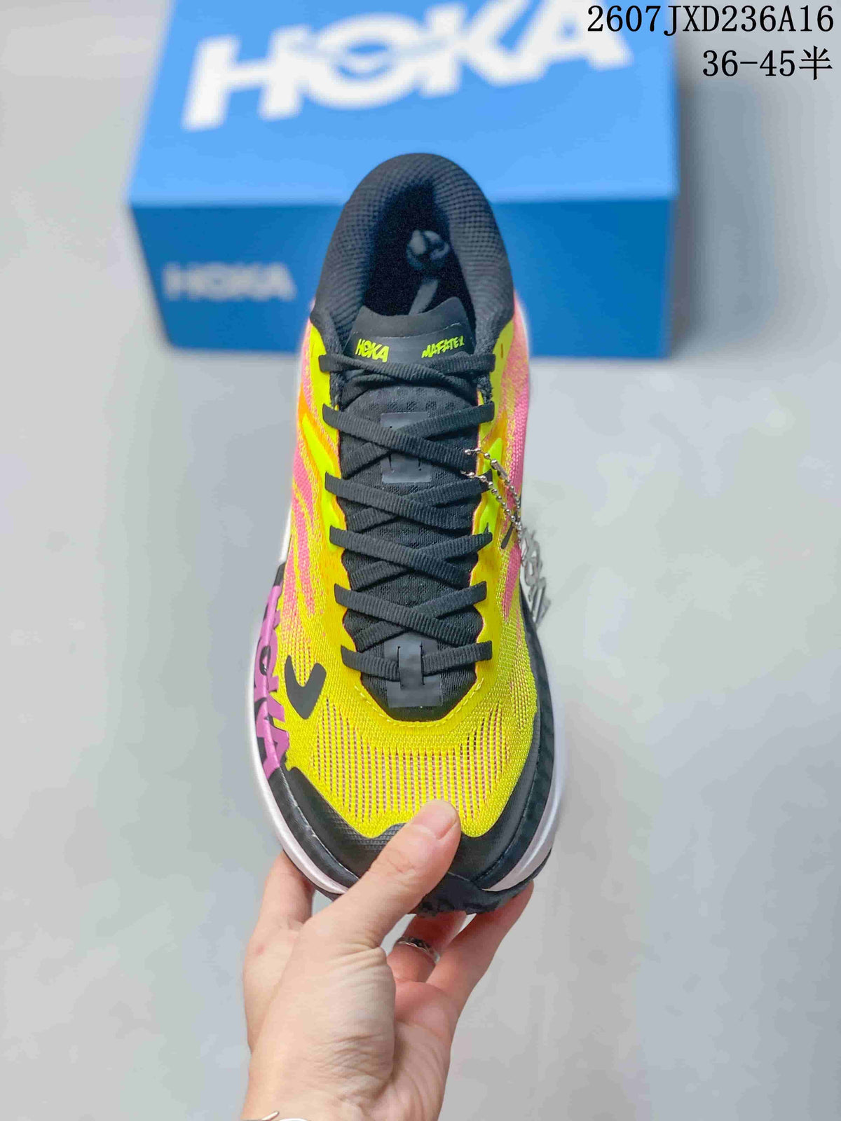 Top view of the MAFATE X shoe showing black laces, a yellow and pink upper, and visible Hoka and MAFATE branding on the tongue.