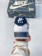 Rear view showing a navy heel tab, white heel panel, and dark midsole.