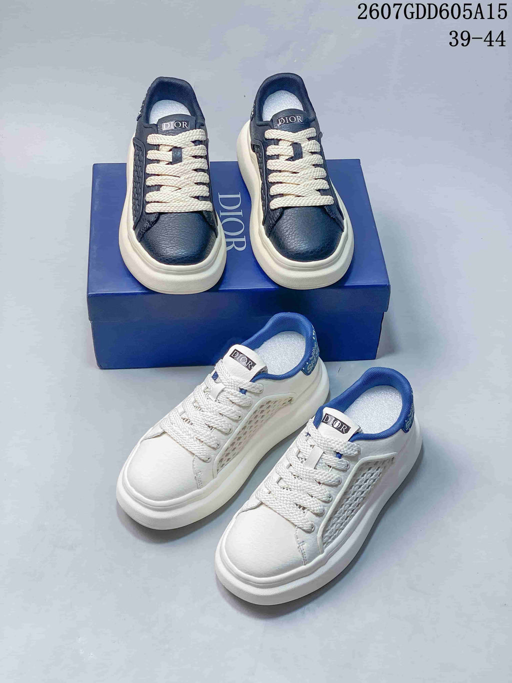 Navy and white Dior sneaker colorways arranged together on and beside a blue shoe box; overlay shows style code 2607GDD605A15 and size range 39–44.