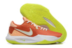 Orange, white, and bright yellow-green basketball shoe shown beside its tread.