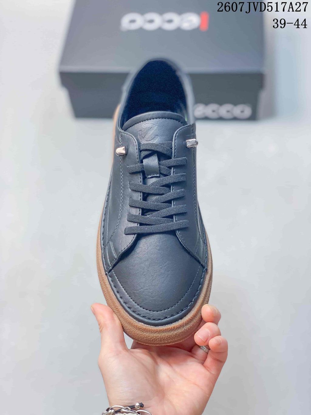 Top view of the dark navy lace-up sneaker showing the rounded toe, tongue, laces, and metallic lace details.