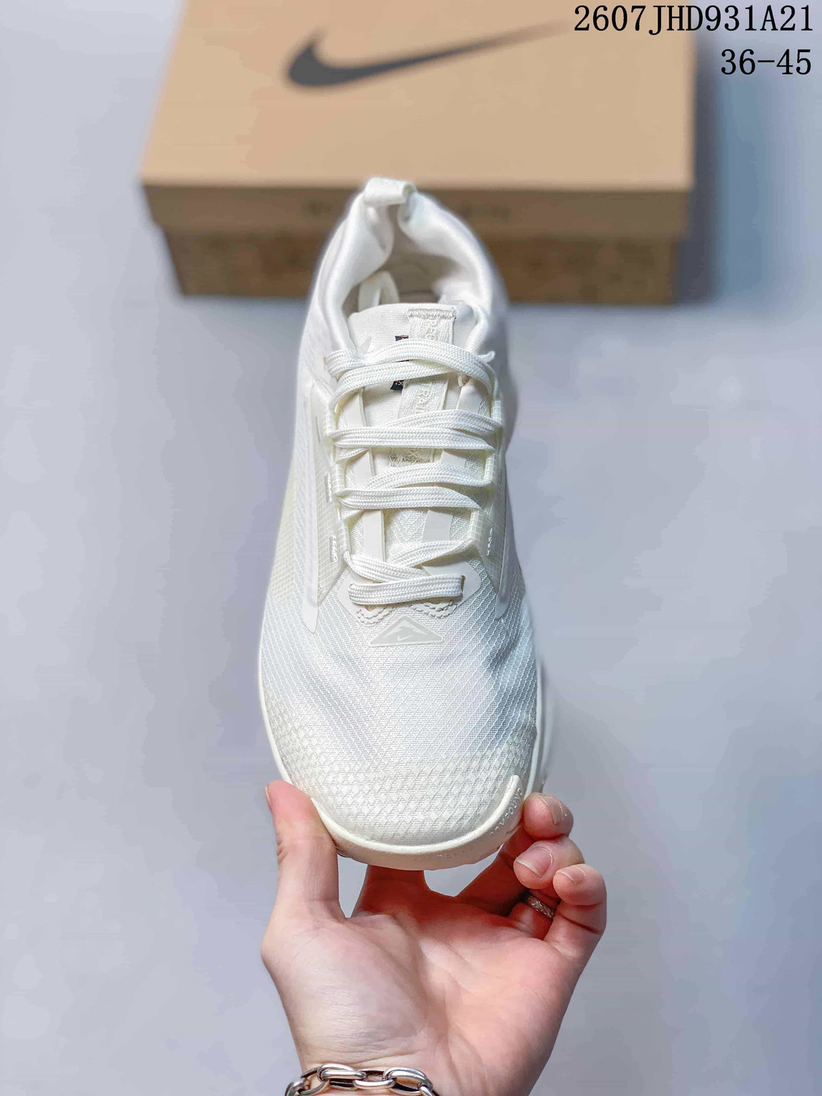 Top view of the white lace-up sneaker showing the textured toe box, tongue, and white laces.
