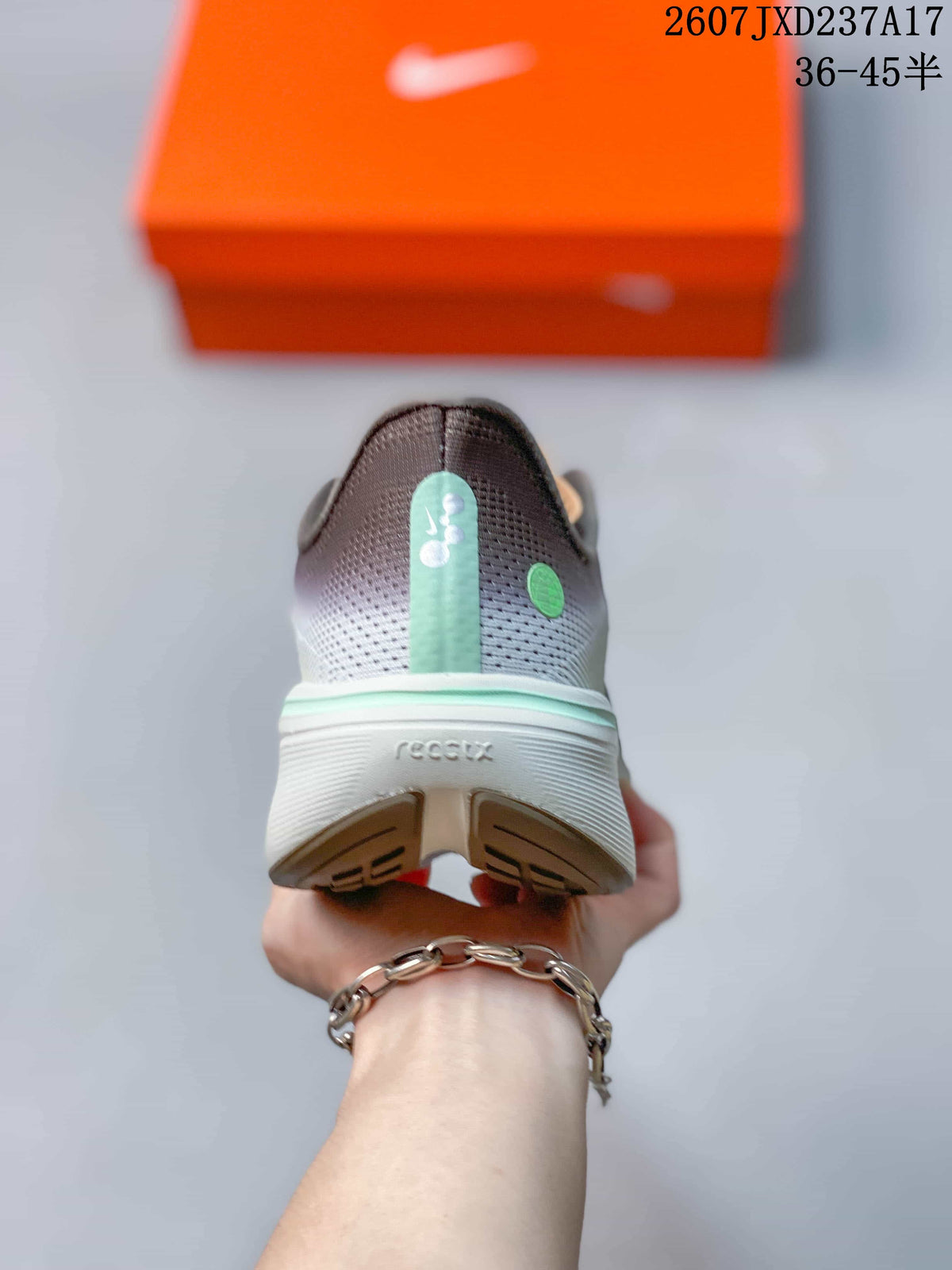 Rear view of the sneaker showing the heel design, mint accent strip and textured outsole.