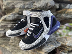 Close angled view of the laces, side Swoosh, and patterned ankle strap