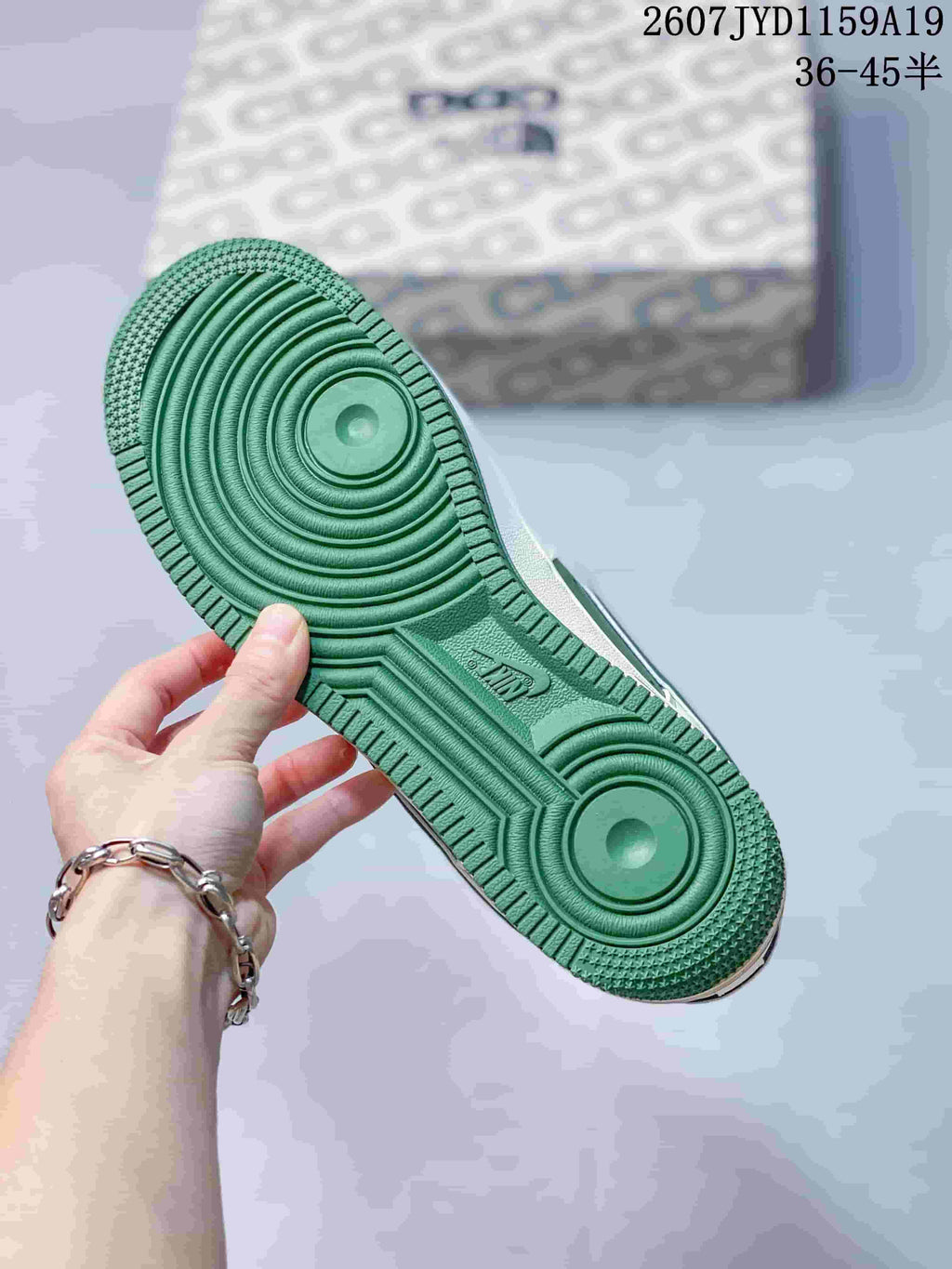 Green outsole shown from below, featuring circular traction zones and textured tread.