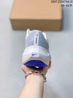 Rear view of a white Nike running sneaker with a blue logo and blue outsole detail.