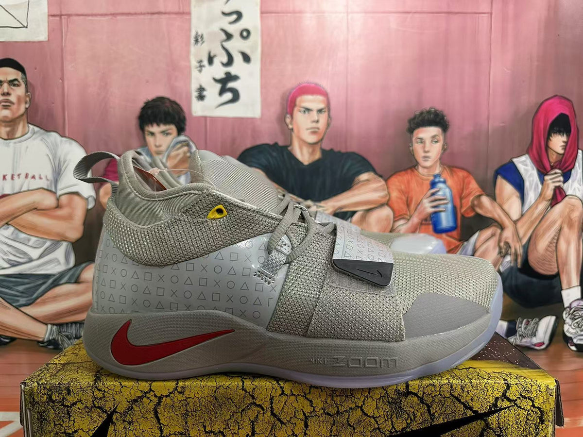 Side view of a grey Nike basketball shoe with a red Swoosh and patterned side panel.