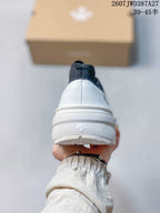 Rear view showing the white heel, navy pull tab, and raised heel branding.
