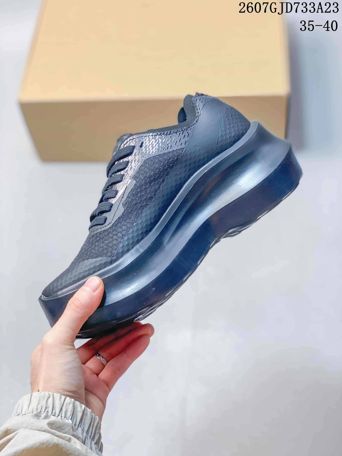 Side profile showing the layered upper, lace closure, and thick raised sole.