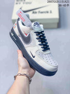 Angled side view showing the white and navy color blocking, layered Swoosh details, heel branding, and navy outsole.