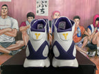 Rear view of white and purple Kobe basketball sneakers with gold heel logos; size label visible inside.
