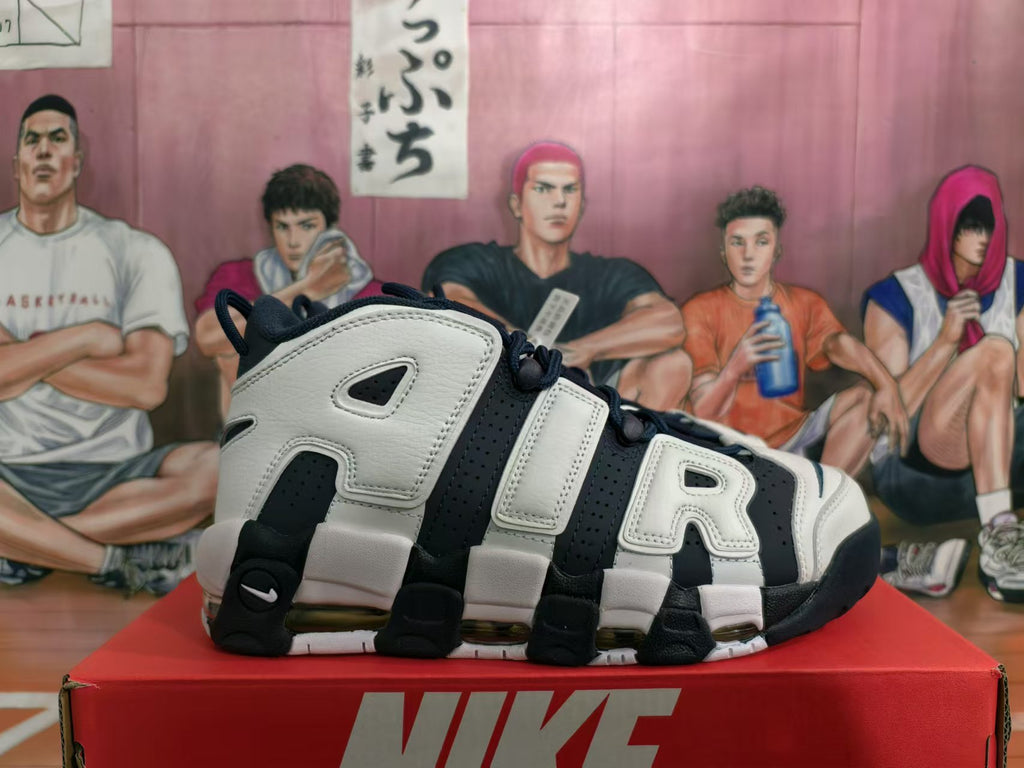 Side view showing oversized AIR lettering and visible cushioning units on a Nike basketball shoe.