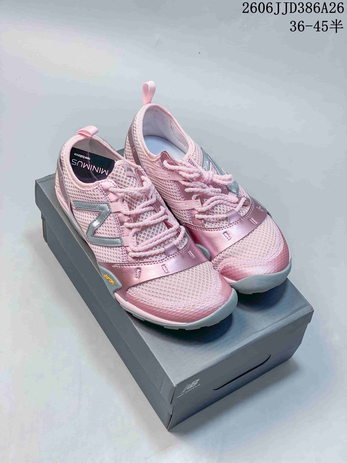 Pair of pink and silver-gray New Balance low-top sneakers displayed on a shoebox.