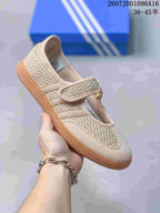 Side view of a beige Adidas Samba Jane W sneaker showing the textured upper, strap closure and gum-colored outsole.
