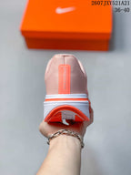 Rear view of a pale pink sneaker showing the heel construction, coral outsole edge, and vertical Pegasus branding.