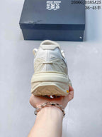 Rear view of the ivory hiking shoe with its lugged outsole