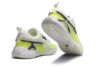 Rear and outsole views of white and fluorescent lime Jordan Heir shoes