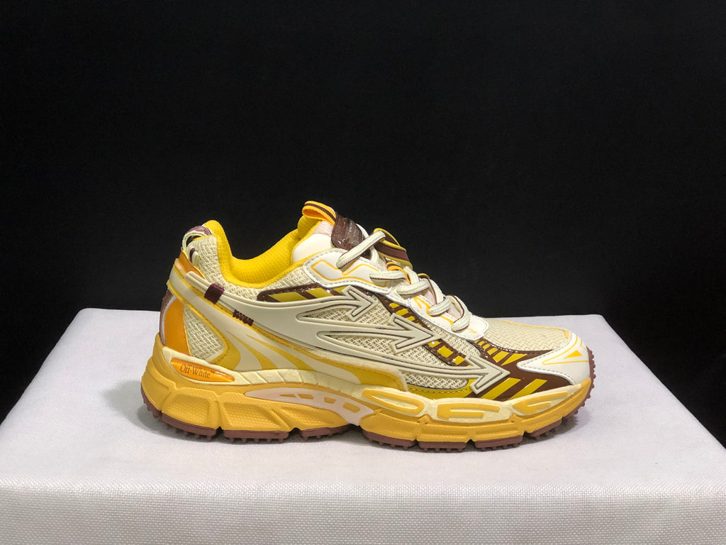 Outer side profile of one sneaker showing the lace-up construction, layered upper, and yellow segmented sole.
