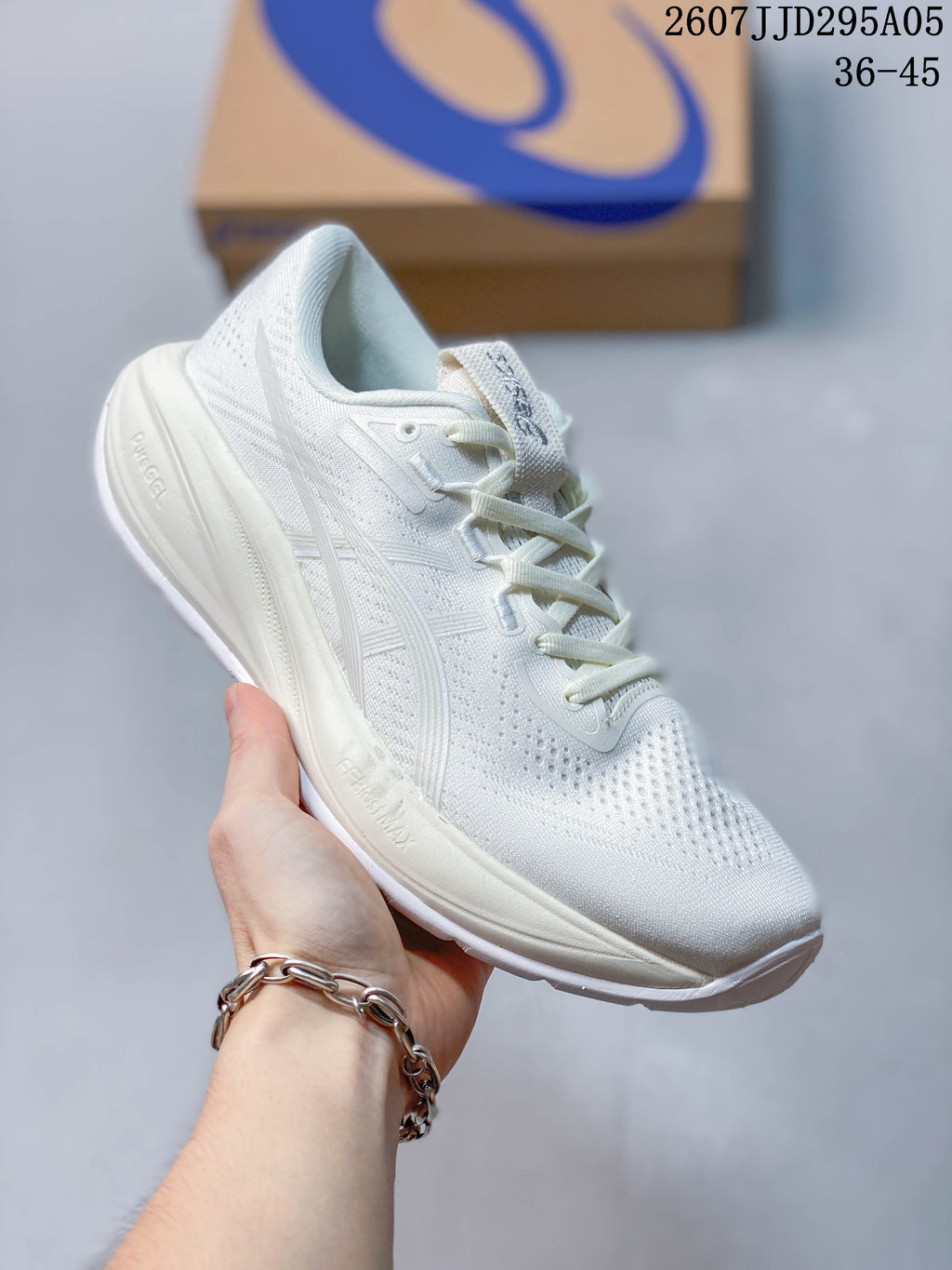 Angled side view of the white ASICS running shoe showing the mesh upper, side branding and thick midsole.