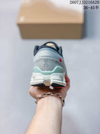 Rear view showing the gray heel, pale mint-green heel detail, and segmented outsole.