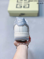 Rear view of the sneaker showing the padded collar, heel construction, and gray-blue outsole.