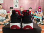 Rear view of black and red Jordan sneakers showing heel details, white midsoles, and red outsole sections.