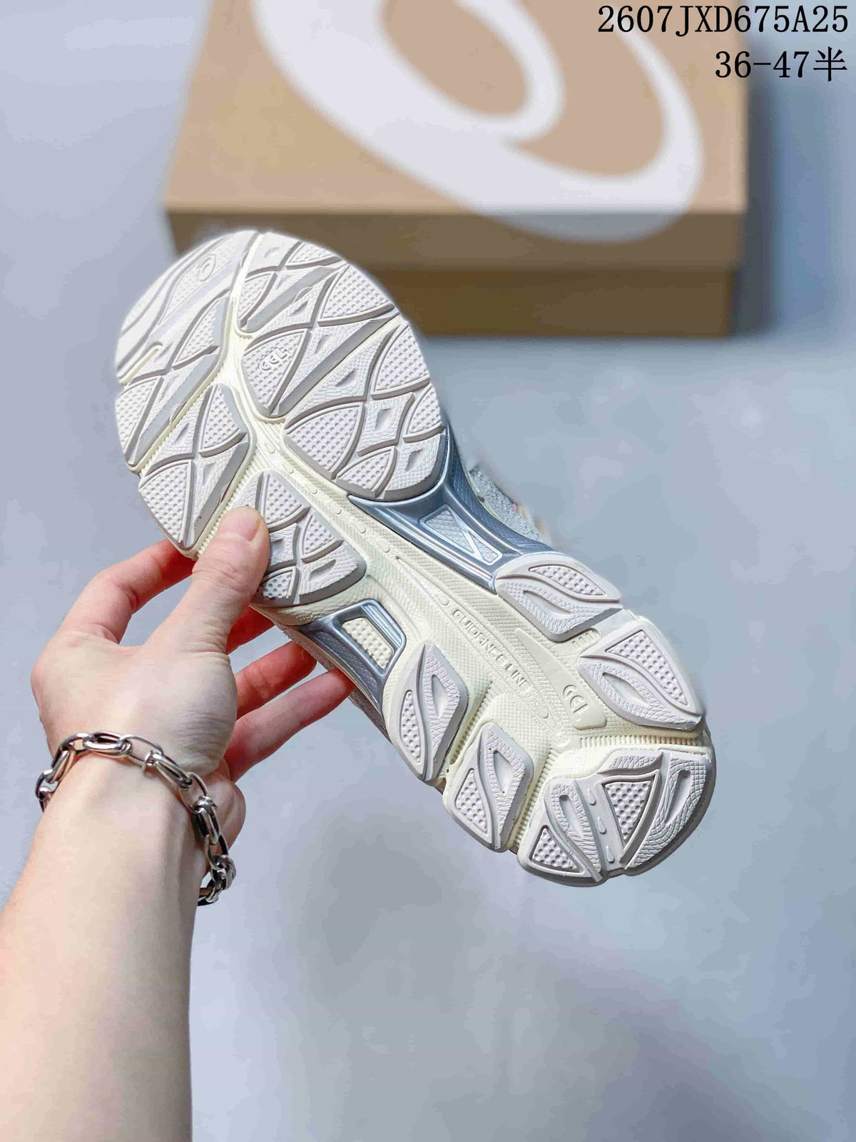 Close-up of the patterned rubber outsole and tread of an ASICS GEL-NYC sneaker.