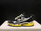 Full lateral profile highlighting the layered side arrows and sculpted black, white, and yellow sole.