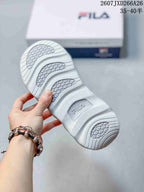 Close-up of the textured white and gray outsole showing segmented tread areas and FILA branding.