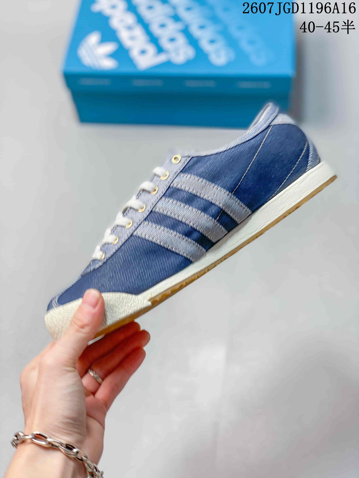 Side view showing the blue upper, contrasting stripes, white midsole, and gum outsole.