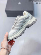 Side profile of the white and gray low-top hiking shoe showing its structured upper, layered overlays, and rugged outsole.