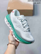 White On Cloudsurfer 3 sneaker with a bright green midsole and white sculpted outsole.