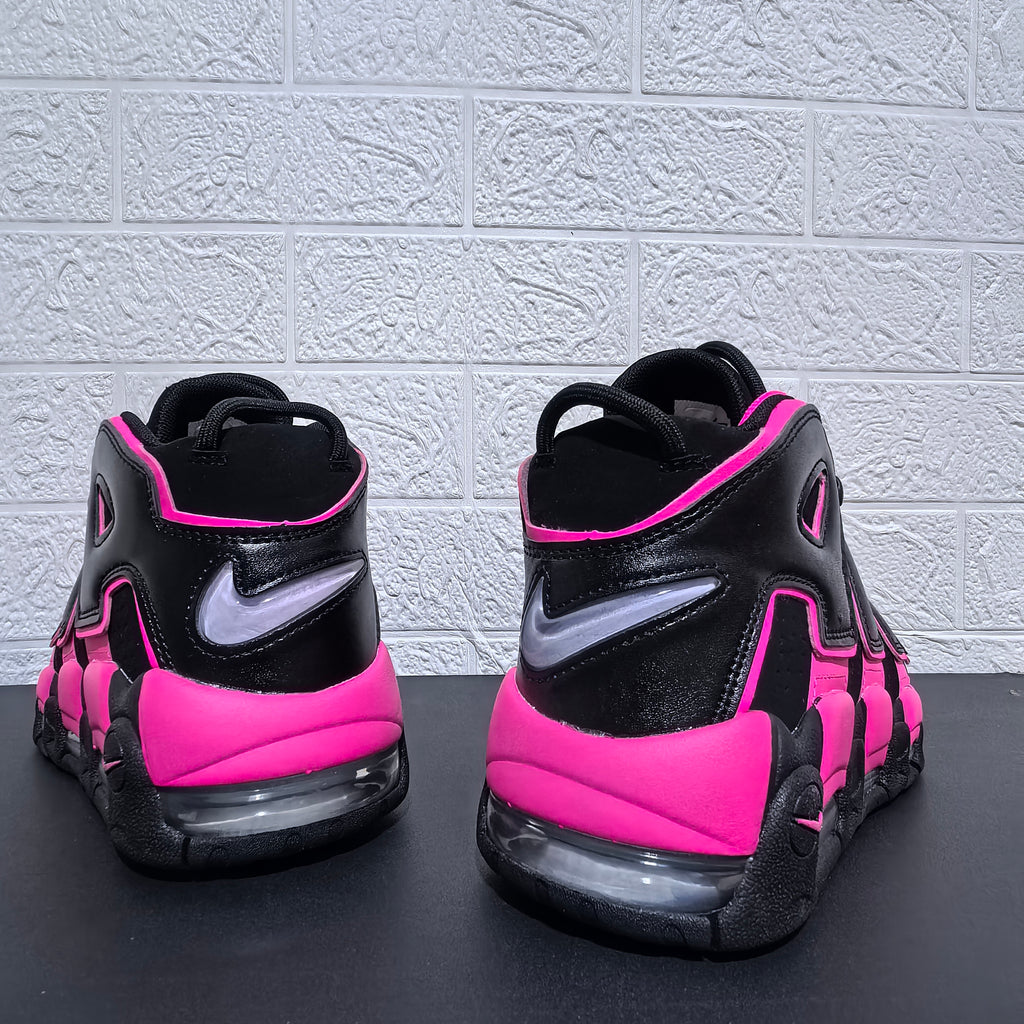 Rear view of black and pink Nike Air More Uptempo sneakers