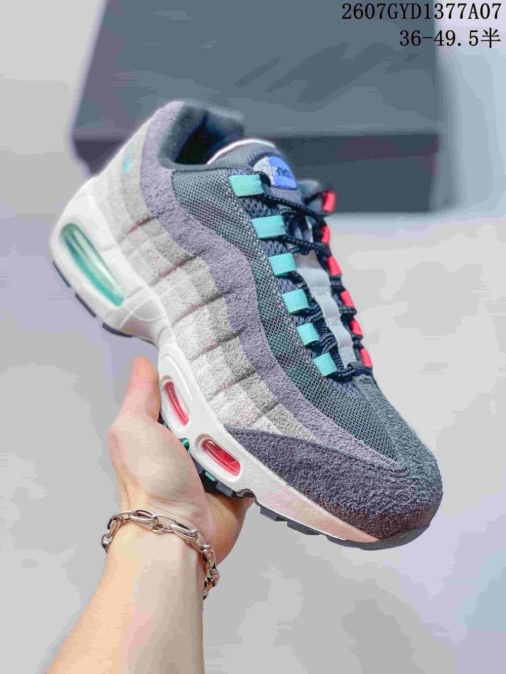 Angled side view of a grey Nike Air Max 95 sneaker showing the layered side panels and visible Air windows.