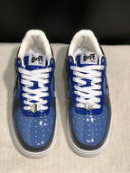 Front view of the pair showing white laces, metallic lace hardware, and blue-gray toe panels.