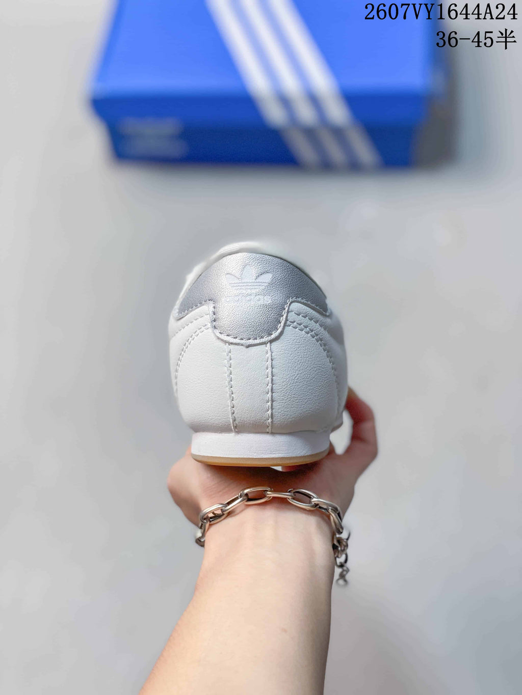 Rear view of the white sneaker showing the heel panel and adidas logo detail.