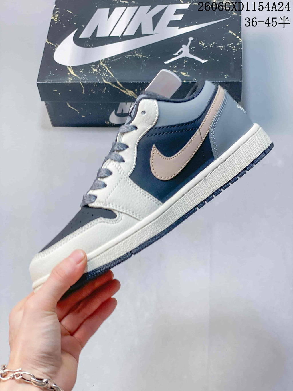 Side profile showing cream panels, gray heel, and contrasting side emblem