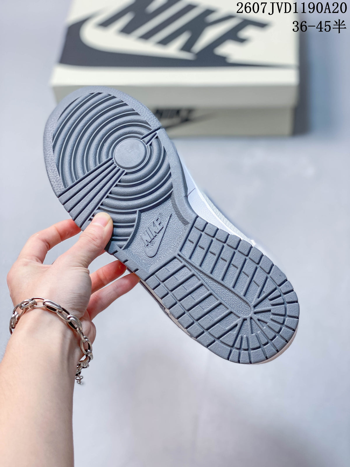 Close view of the grey rubber outsole showing its circular and block-pattern traction.