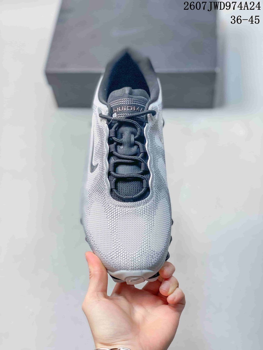 Top view of a silver-gray Nike Air Liquid Max sneaker showing the dark lace area, padded collar and rounded toe.