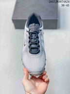Top view of a silver-gray Nike Air Liquid Max sneaker showing the dark lace area, padded collar and rounded toe.