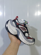 Angled view of the Skechers 1101 sneaker showing the mesh upper, side logo detail, gray midsole accent and black outsole.