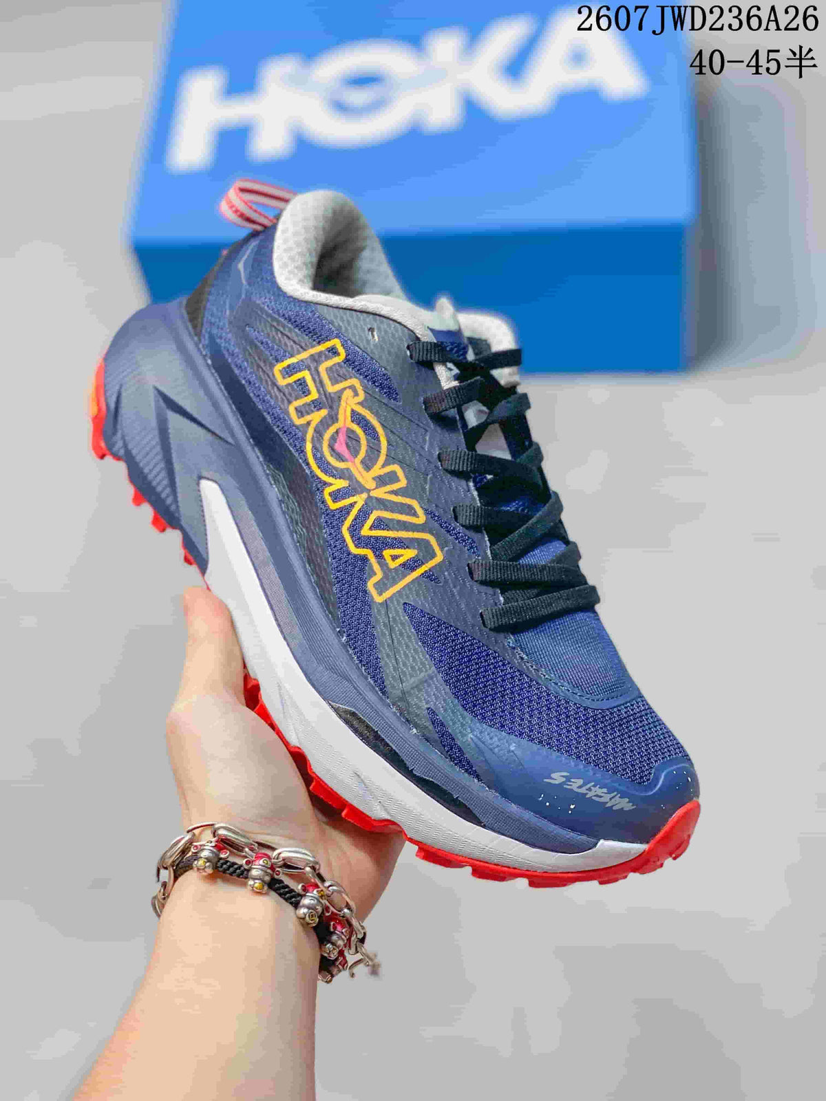Angled side view of the navy trail shoe with contrasting red outsole and HOKA branding.