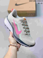 Gray Nike Zoom Fly 5 sneaker with a bright pink Swoosh and mint accents, photographed in front of a shoe box.