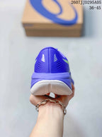 Rear view of the purple sneaker showing the heel structure, ventilation details, and white outsole.
