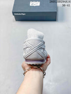Rear view of the light gray low-top sneaker showing the layered heel panels, padded collar, and textured outsole edge.