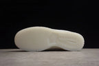 Side view of the translucent-style white outsole and circular forefoot tread.