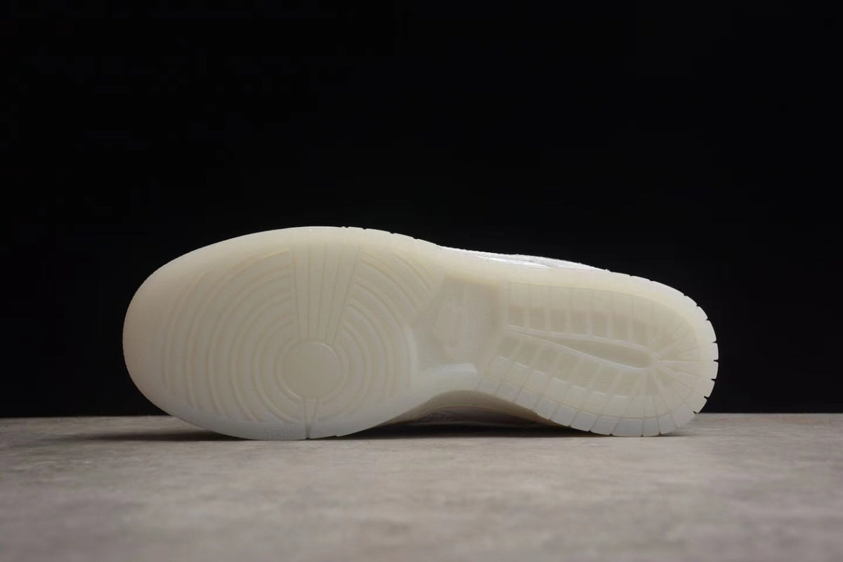 Side view of the translucent-style white outsole and circular forefoot tread.