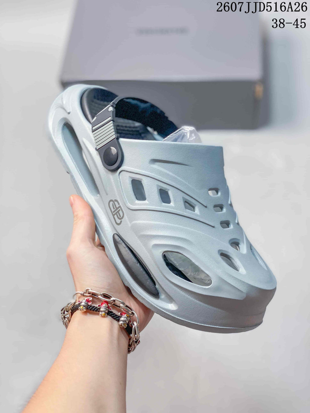 Angled view of the light gray platform clog sandal showing the cutout design and adjustable strap.