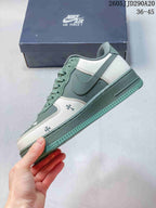 Side profile showing the contrasting Swoosh, layered green and white panels, lace-up closure, and green sole.