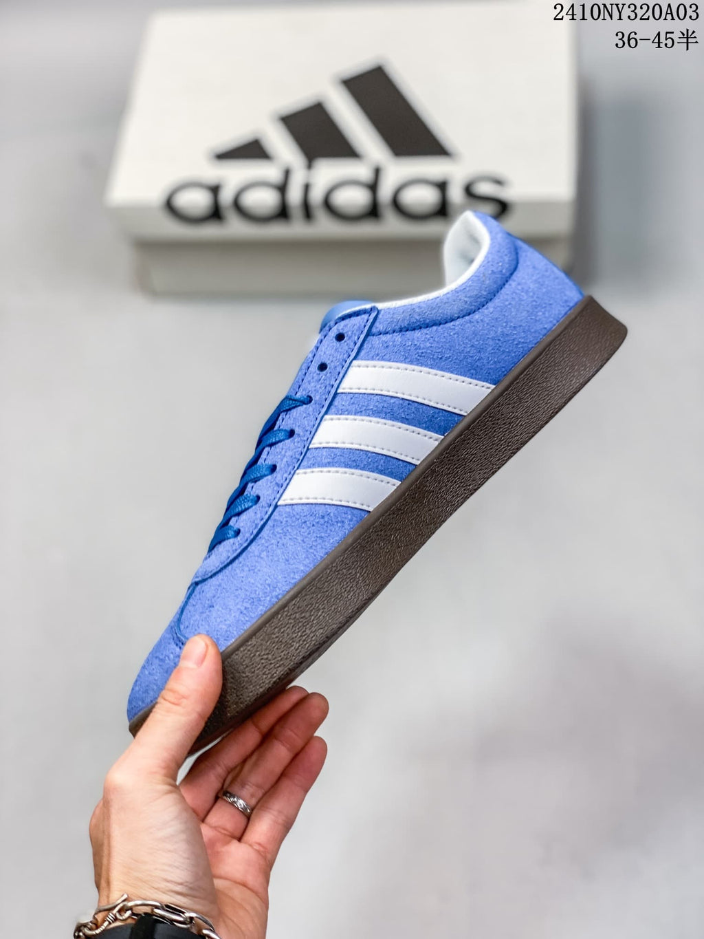 Side view highlighting the blue upper, white stripes and brown outsole.
